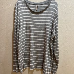 Grey and white striped long sleeve top with button details at the wrists